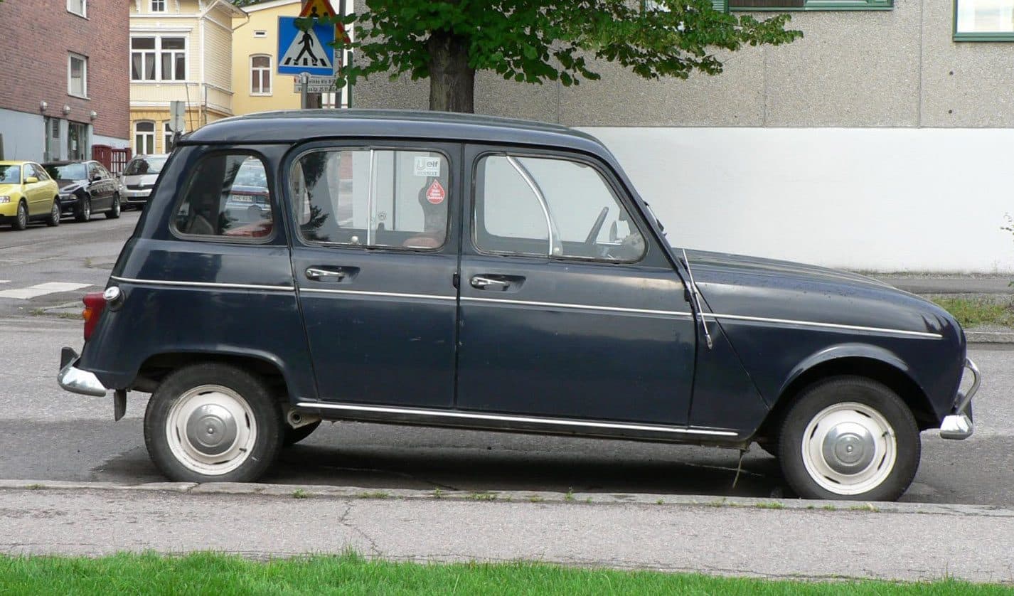 Fotografia de um Renault 4 clássico azul-escuro, perfil lateral